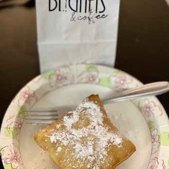 Way Down Yonder Beignets & Coffee - a piece of pastry on a plate with a fork - Coffee & Tea Near Me - Columbus, Ohio