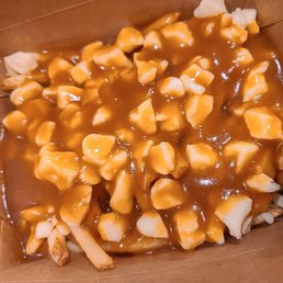 a box of fries covered in caramel sauce a box of fries covered in caramel sauce