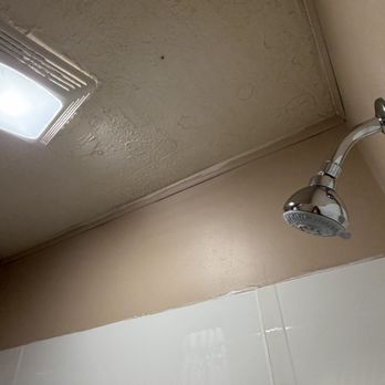 Sunset Motel on the Bay - The shower ceiling was a mess (also, there's that stupid fly!!) - Hotels Near Me - Munising, Michigan