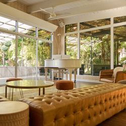The Rochers at the Ranch House - Our lounge offers garden views through full-length windows--complete with a gleaming white grand piano to set the tone.