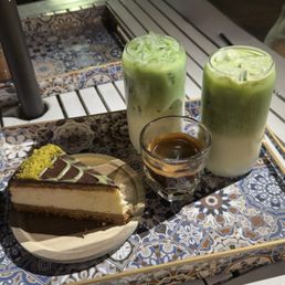 Matcha Latte with Pistachio syrup, shot of coffee, & Dubai cheesecake