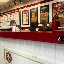 Firehouse Subs - 1 person working while the others are talking about personal business.