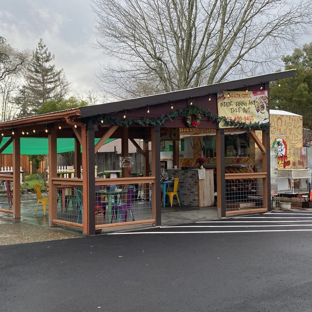 The food truck, and the outside eating area The food truck, and the outside eating area
