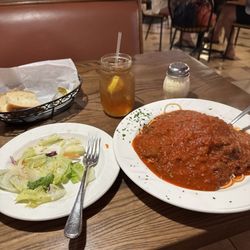 Spaghetti Bolognese, side salad, and bread.