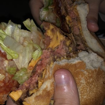 McDonald's - a person holding a large sandwich - Fast Food Near Me - Latham, New York McDonald's - a person holding a large sandwich - Fast Food Near Me - Latham, New York