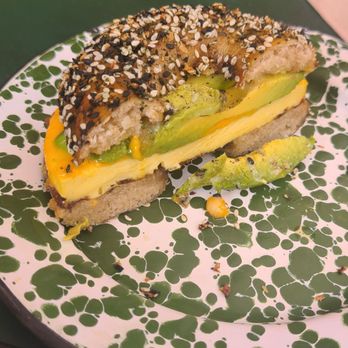 Pinyon - Half of egg, cheese, and avocado sandwich on everything bagel. (Substituted bacon for avocado) - Bakeries Near Me - Ventura, California