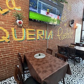 Hola Tacos Cleveland - a television mounted on a brick wall - Mexican Near Me - Cleveland, Ohio Hola Tacos Cleveland - a television mounted on a brick wall - Mexican Near Me - Cleveland, Ohio