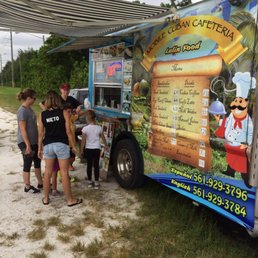 a group of people standing in front of a food truck