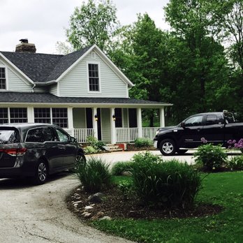 Trimline Lawn Care Services - a house with a car parked in front of it - Landscaping Near Me