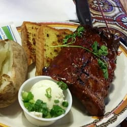 Texas Cattle - Slab of baby back, baked potato, and garlic toast.