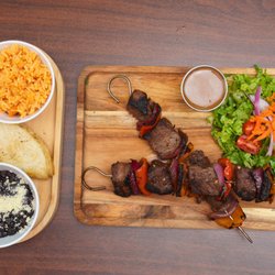 Quiero Tacos - Steak on a stick, but make it gourmet! Two skewers of tender, marinated carne asada with grilled onions and peppers. Served with rice, beans
