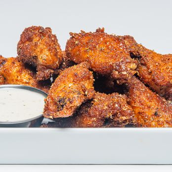 Wing Squad - a plate of chicken wings with dipping sauce - Food Delivery Services Near Me Wing Squad - a plate of chicken wings with dipping sauce - Food Delivery Services Near Me