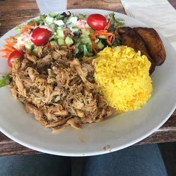 Sofrito Latin Cafe - Roasted Pork with yellow rice, salad and plantains. Delicious - Latin American Near Me - Orlando, Florida Sofrito Latin Cafe - Roasted Pork with yellow rice, salad and plantains. Delicious - Latin American Near Me - Orlando, Florida