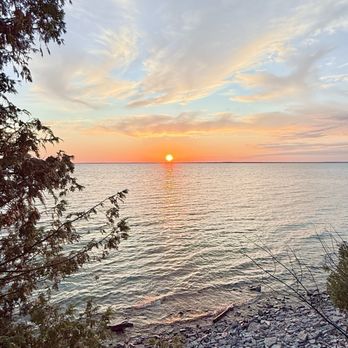 Fayette State Park - Private spot to view sunset between the trees on the handicap parking road that connects the campground and village - Parks Near Me - Garden, Michigan