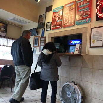 Roper's Ribs - a man and a woman standing in front of a counter - Barbeque Near Me - Saint Louis, Missouri Roper's Ribs - a man and a woman standing in front of a counter - Barbeque Near Me - Saint Louis, Missouri