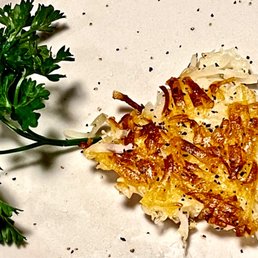 A piece of my husband's hash browns from the classic breakfast he ordered.   It was delicious!!! Cooked perfectly, in a most excellent way.