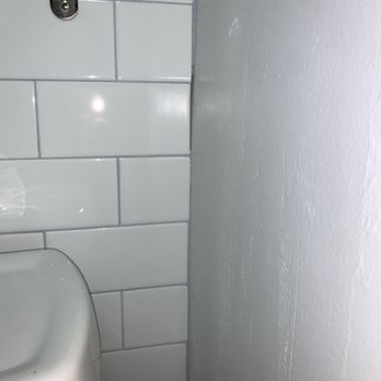 Details Tile - Grout not completed around the wall. Chunks missing, as they were cutting corners. - General Contractors Near Me - Dallas, Texas Details Tile - Grout not completed around the wall. Chunks missing, as they were cutting corners. - General Contractors Near Me - Dallas, Texas