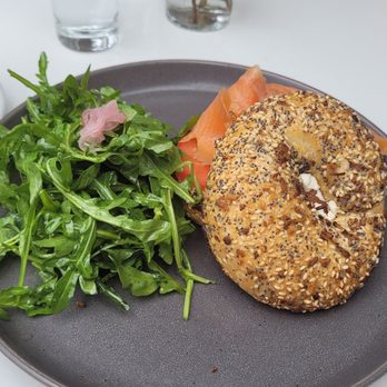 Milligram  - Smoked salmon and cream cheese bagel. Perfectly paired with this side of greens, dressed in a simple and light dressing. - Cafes Near Me - Costa Mesa, California