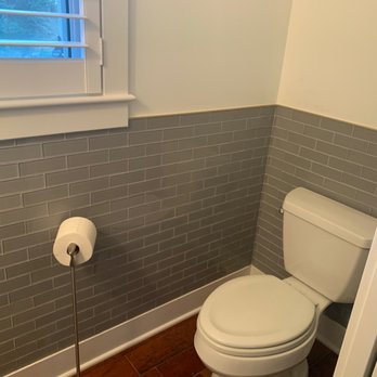 Distinct Tile Service - a toilet in a bathroom - Tiling Near Me