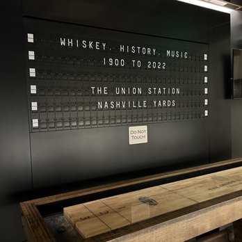 Ergo - a wooden bench in front of a wall with a sign that reads whiskey history, music, and the union station nashville yards - Breakfast & Brunch Near Me - Nashville, Tennessee Ergo - a wooden bench in front of a wall with a sign that reads whiskey history, music, and the union station nashville yards - Breakfast & Brunch Near Me - Nashville, Tennessee