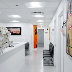 CG Cosmetic Surgery - Consultation reception desk: Reception counter with nearby seating and a glass display.