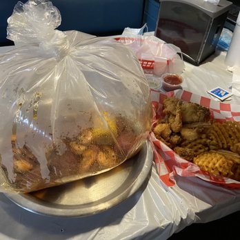 Seafood Island - sausage and shrimp cajun steamer bag & Fried Basket w/ catfish, shrimp and oysters and waffle fries - Cajun/Creole Near Me - Shawnee, Kansas Seafood Island - sausage and shrimp cajun steamer bag & Fried Basket w/ catfish, shrimp and oysters and waffle fries - Cajun/Creole Near Me - Shawnee, Kansas