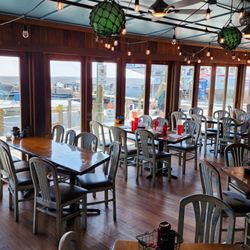 AJs Seafood & Oyster Bar - Indoors with a view of the boats on the dock.