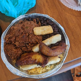 La Cocina De Abuela - Meat: (left) Saucy shredded beef- ropa vieja, plantains, black beans, 2 yucca fried sticks yellow rice on the bottom - Cuban Near Me - Gainesville, Florida