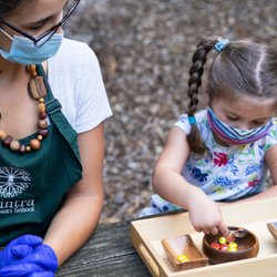 Abintra Montessori School - Spooning supports the development of eye-hand co-ordination and is a part of the Practical Life curriculum in the Lower School Program.