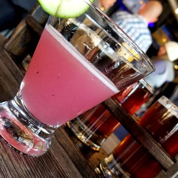 HELLUVA Brewing Company - Blueberry Cucumber Gimlet in front of a beer flight. - Brewpubs Near Me - Chandler, Arizona