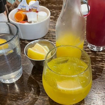 First Watch - "Morning glory" (yellow/orange one) "Pomegranate Pear Punch" (red one) Lemon water - Breakfast & Brunch Near Me - Winston-Salem, North Carolina
