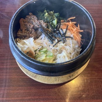 Sushi Express - Stone Pot Bibimbap (beef)- Hot iron bowl with rice at the bottom that overtime gets crispy with your choice of meat, veggies and an egg. - Korean Near Me - San Antonio, Texas Sushi Express - Stone Pot Bibimbap (beef)- Hot iron bowl with rice at the bottom that overtime gets crispy with your choice of meat, veggies and an egg. - Korean Near Me - San Antonio, Texas