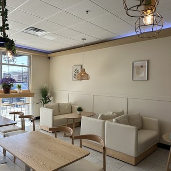 Overbaked - a living room with a table and chairs - Desserts Near Me - Newark, Delaware