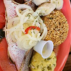 Hillside Terrace - Local yellowtail boiled with 3 sides (green bananas, rice and peas (rice and beans) and fungi (okra). Pickled onions on top.