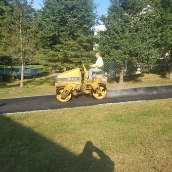 J&R Contracting - a man riding a road roller - Septic Services Near Me - Hudson, New York