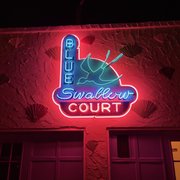 Photo of Blue Swallow Motel - Tucumcari, NM, United States. Sign above the rooms.