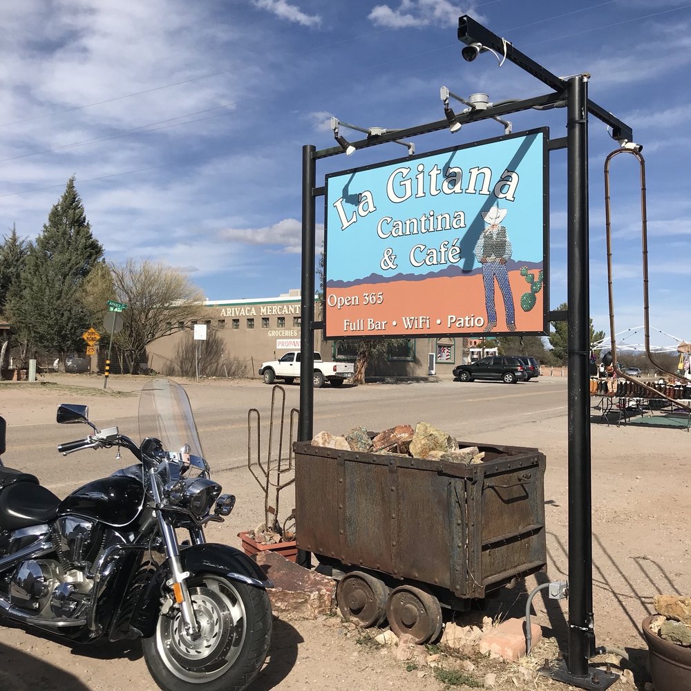 La Gitana Cantina - a motorcycle parked in front of a sign - Bars Near Me - Arivaca, Arizona