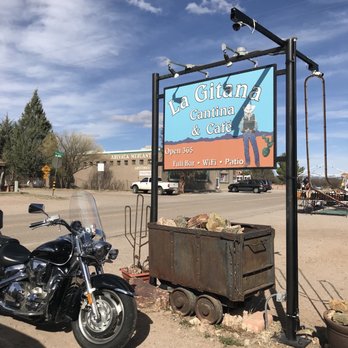La Gitana Cantina - a motorcycle parked in front of a sign - Bars Near Me - Arivaca, Arizona