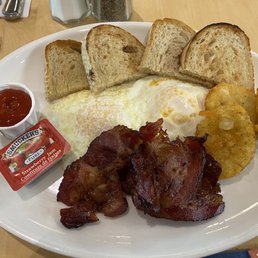 Caplansky's bacon with eggs over easy, hash browns and toast.