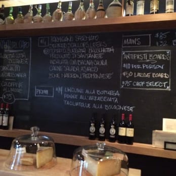 L'ufficio - The menu (perpetually changing) is listed on the blackboard behind the bar area. - Wine Bars Near Me - Vancouver, British Columbia