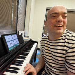 Musical Bridges - One of our adult clients using his AAC device to communicate