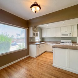 Cal-Prop Management - Large bright open plan kitchen with dining counter and accent colors
