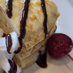 Crepe cake dessert with gross hershey syrup