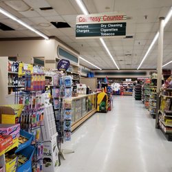 Leppinks Super Market - Dry cleaning sign cleverly hidden by all of the water stained ceiling pieces that no one can be bothered to replace.