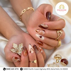 Paradise Nails - Spiced chocolate chic! Pointed almond nails blend rich mocha, tortoiseshell swirls, gold chrome ribbons, and a cute heart. Book now!