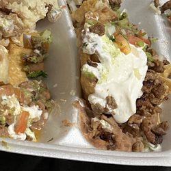 Super nachos and my husband has to dig around the crema.