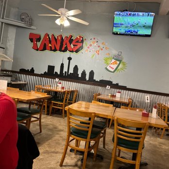 Tank's Pizza - a man sitting at a table - Pizza Near Me - San Antonio, Texas Tank's Pizza - a man sitting at a table - Pizza Near Me - San Antonio, Texas