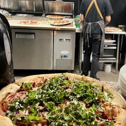Barcuso - With an open kitchen window, you can watch the talented (cute) pizza maker in action
