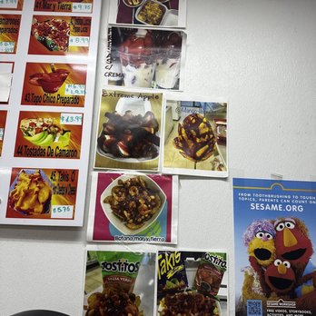 Mango-liciousss - a variety of posters on a wall - Juice Bars & Smoothies Near Me - Mesquite, Texas