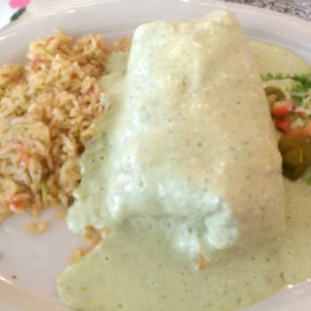 Chuy's - Burrito with seasoned sirloin and their green chile sauce/rice. - Mexican Near Me - San Antonio, Texas